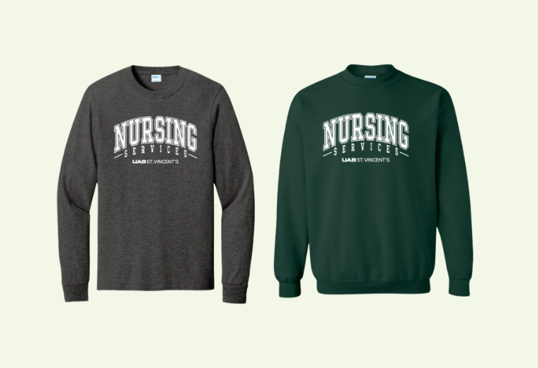 Two sweatshirts side by side; a dark gray long-sleeve and a green sweatshirt, both with "Nursing Services UAB St. Vincent's" printed in bold white letters.