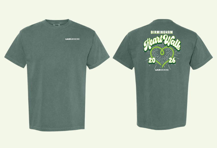 Dark green T-shirt with "UAB Medicine" logo on the front. Back design features "Birmingham Heart Walk 2026" with a heart shape and footprints.