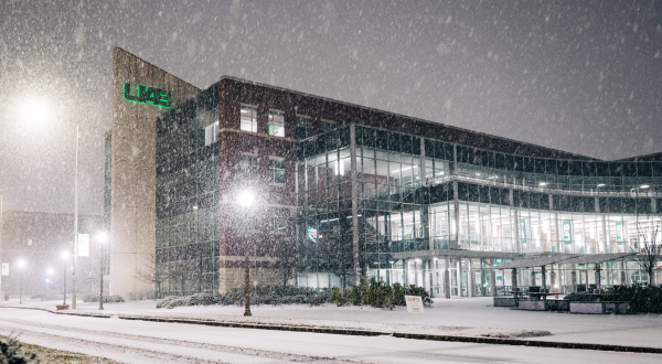 Snow Day, 2025. Exterior of the Hill Student Center during active snowfall with grounds covered in snow at dawn, January 2025.
