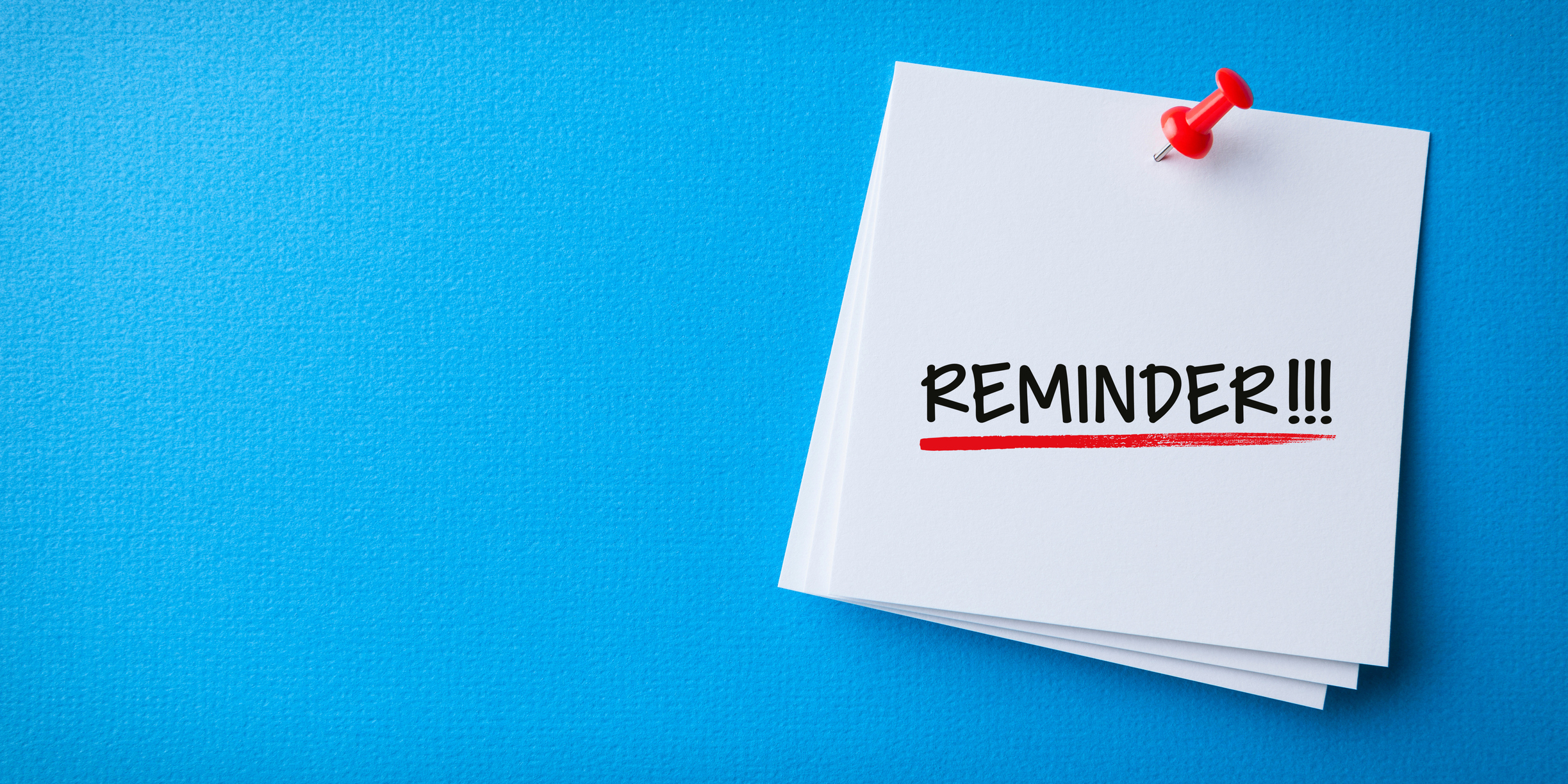 White Sticky Note With Reminder And Red Push Pin On Blue Background